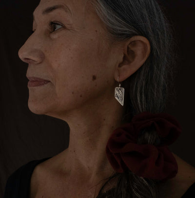 Hand carved sterling silver Hummingbird earrings, Made by Local BC Indigenous women artist, Agnes Seaweed WIsden. Modelled by local Haida Gwaii Resident