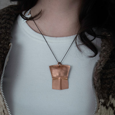 Model wearing copper pendant