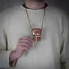 Man wearing copper shield pendant