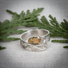 Hand carved 14k gold and silver raven wrap ring with mountains carved by Indigenous Canadian Artist Agnes Seaweed Wisden