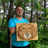 Photo of the Artist holding his work of Hand Carved Red Cedar Raven Stealing the light Haida Oral History story. locally sourced wood form Haida Gwaii BC