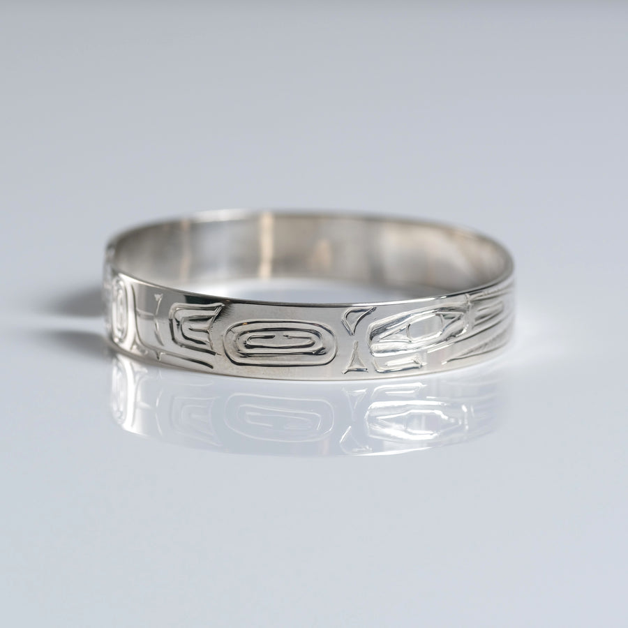 Sterling silver hand-carved Haida 1/4 inch narrow hummingbird cuff bracelet from Crystal Cabin is by Haida Indigenous Canadian artist Garner Moody